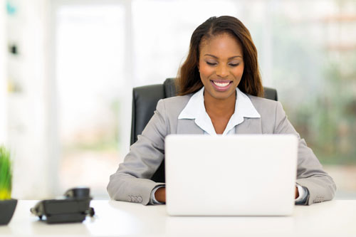 pretty afro american businesswoman using laptop computer