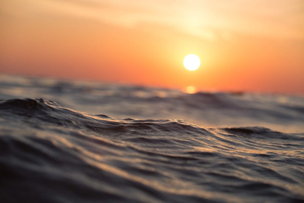 The morning sun over ocean waves and natural rhythms that may affect time of day to meditate